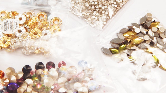 Rhinestones, chains, studs, charms – you name it! Here are the best way to attach those embellishments to your clients’ nails.