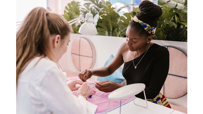 A client choosing a nail color palette.