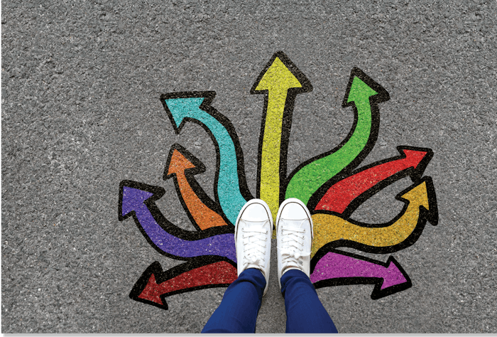 Person wearing shoes standing on top of colored arrows on the ground.