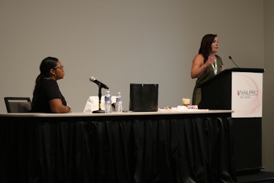 Nailpro Editor-in-Chief Katie Anderson introduces Dominique Coleman, Certified Master Pedicurist at Naturally Beat Feet Nails, at her Advanced Education class at the Nailpro Nail Show.